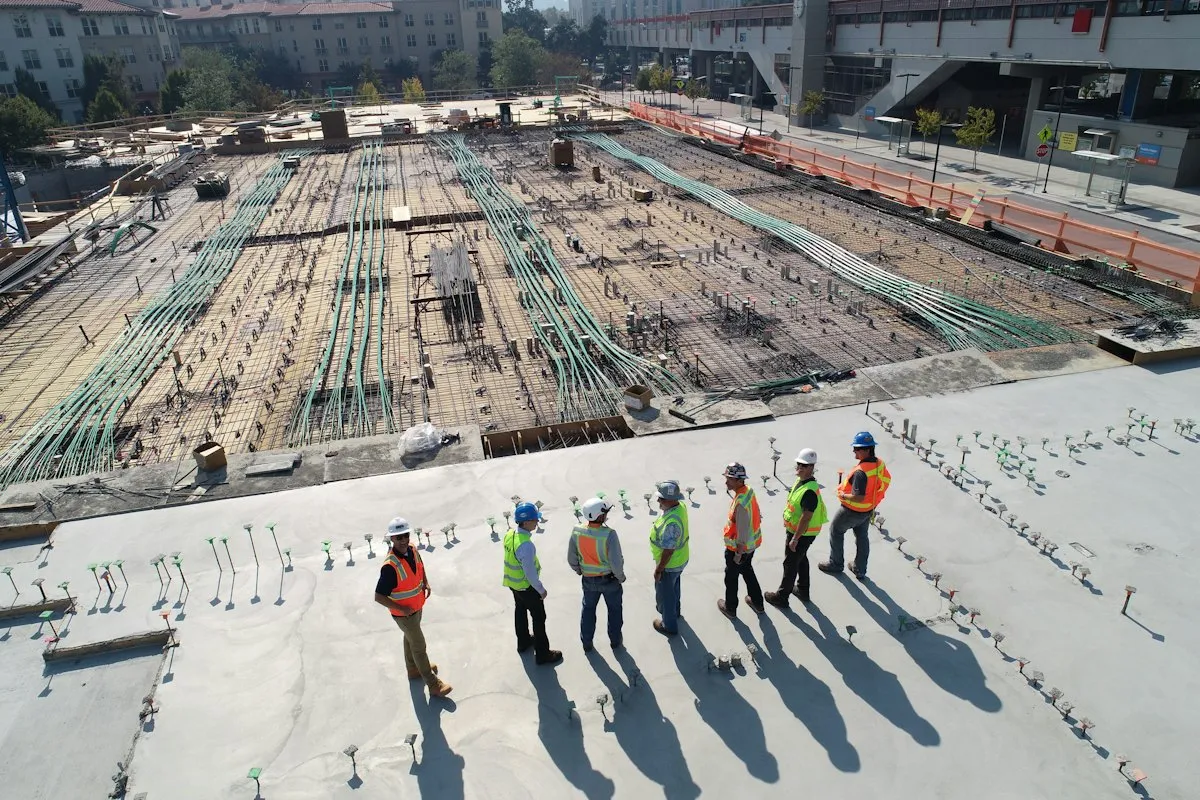 Construction crew reviewing works on a large concrete pour