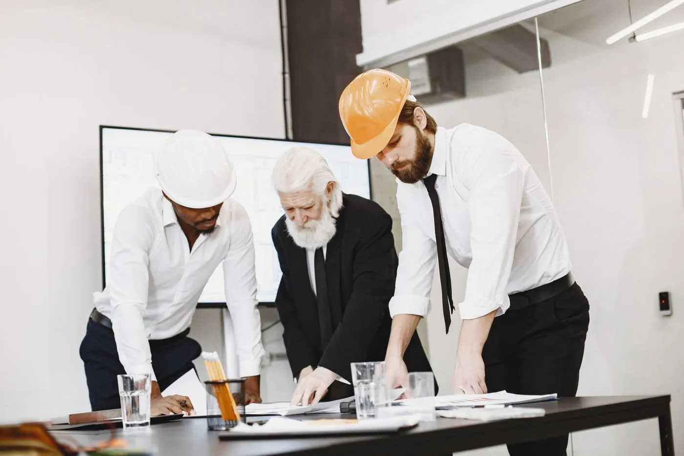 Project team reviewing construction drawings in an office