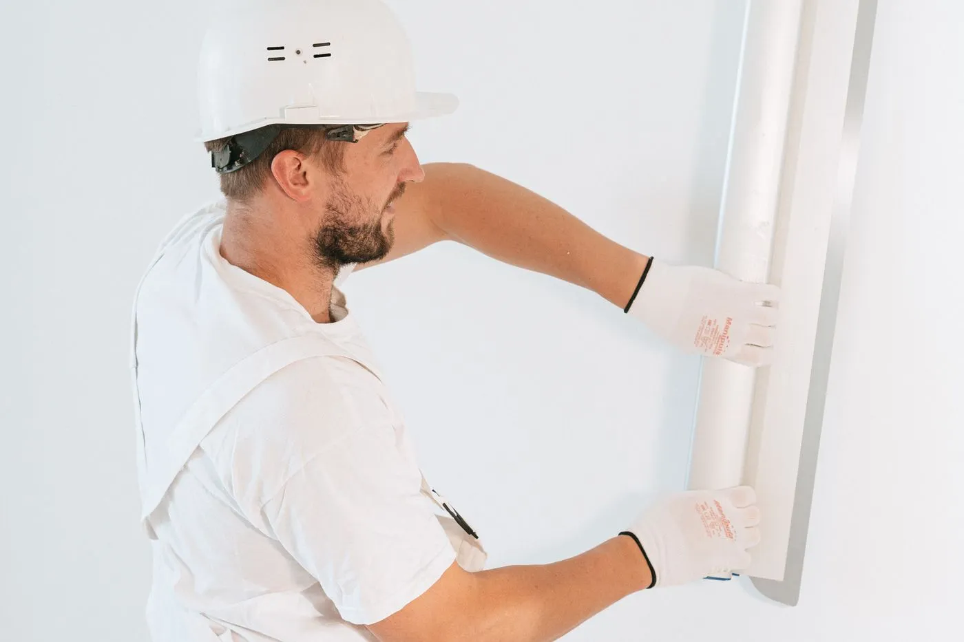 Worker installing gypsum board