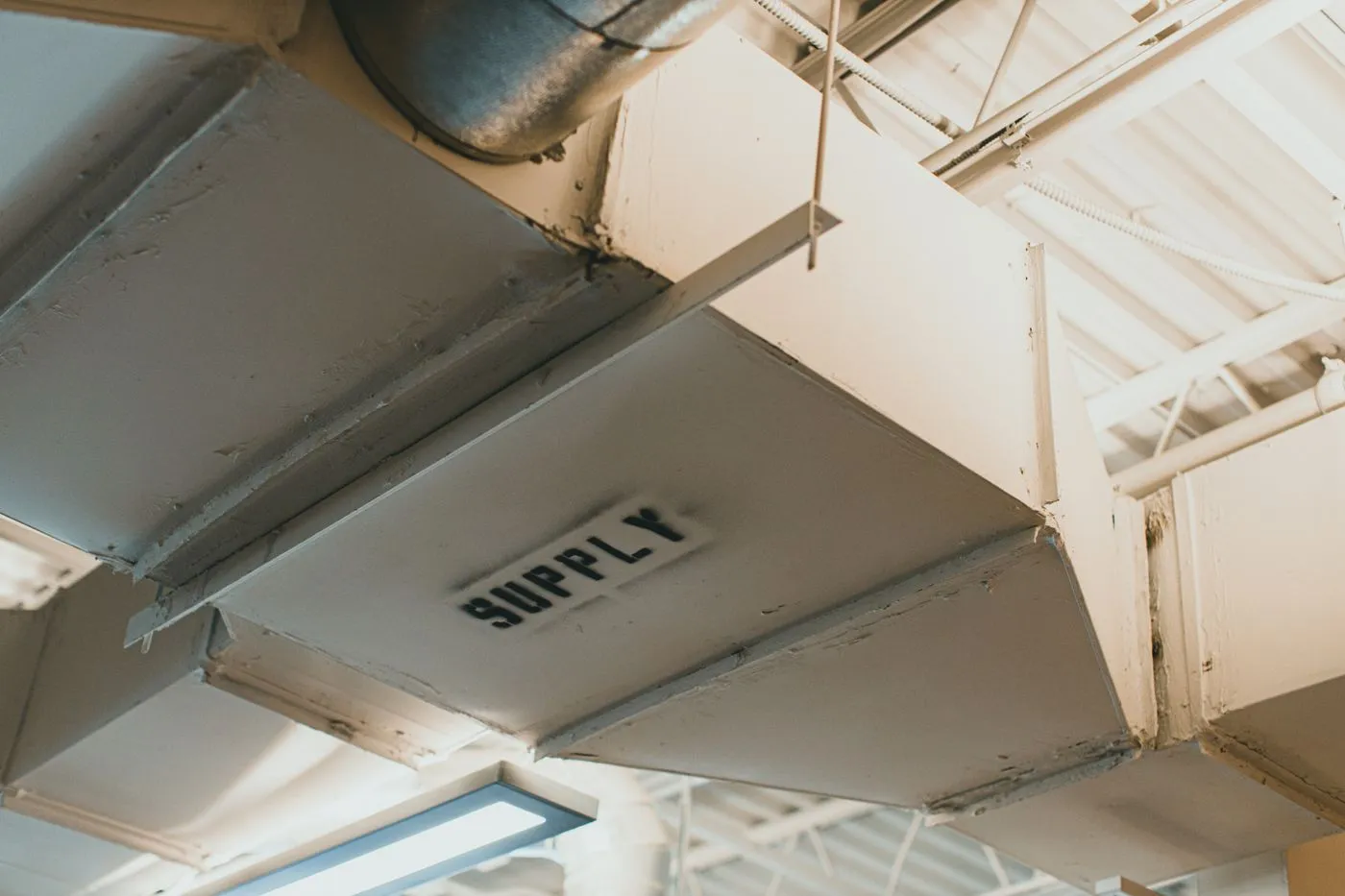 Supply air ductwork running below a ceiling