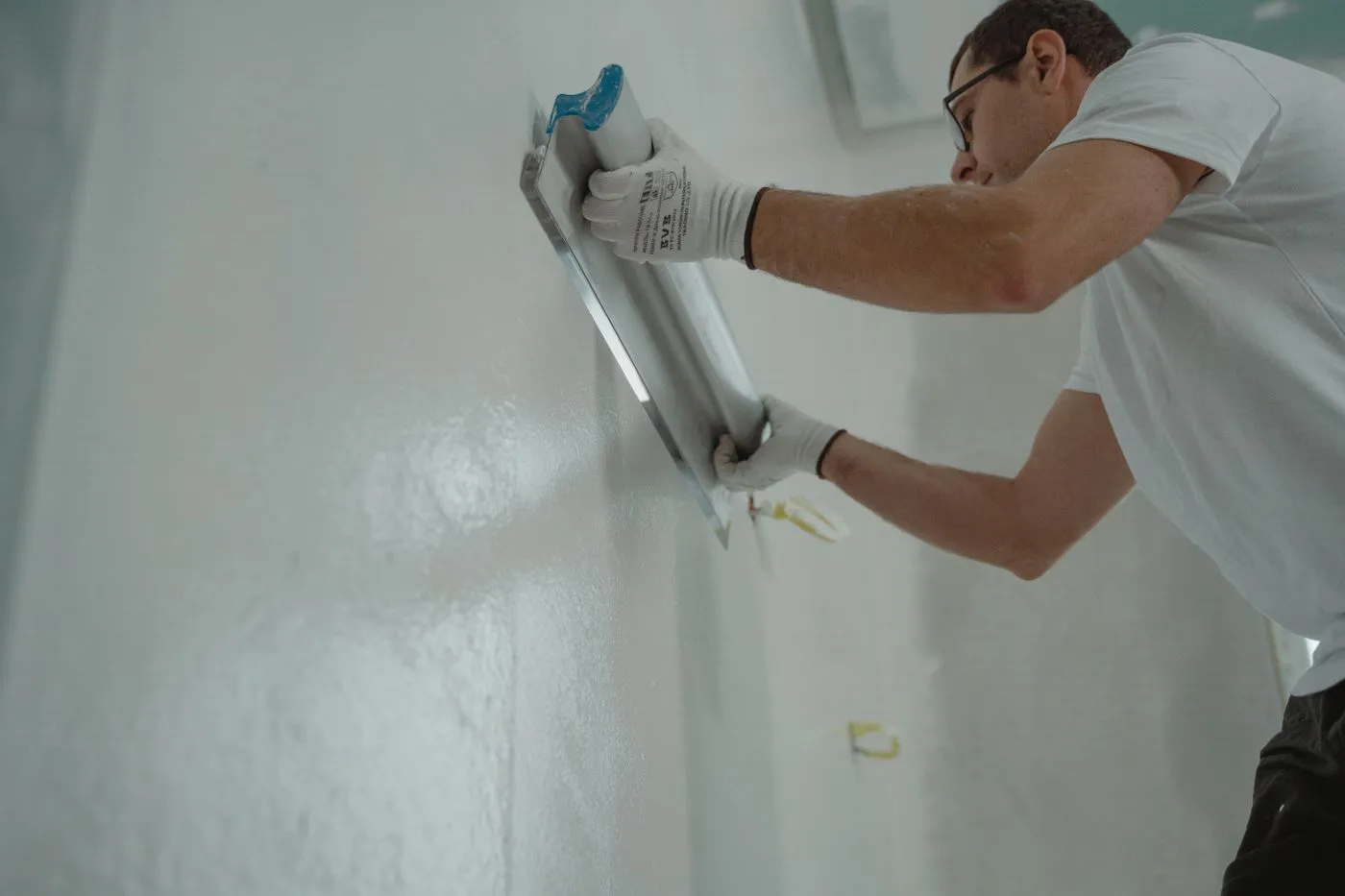Plasterer finishing an interior wall