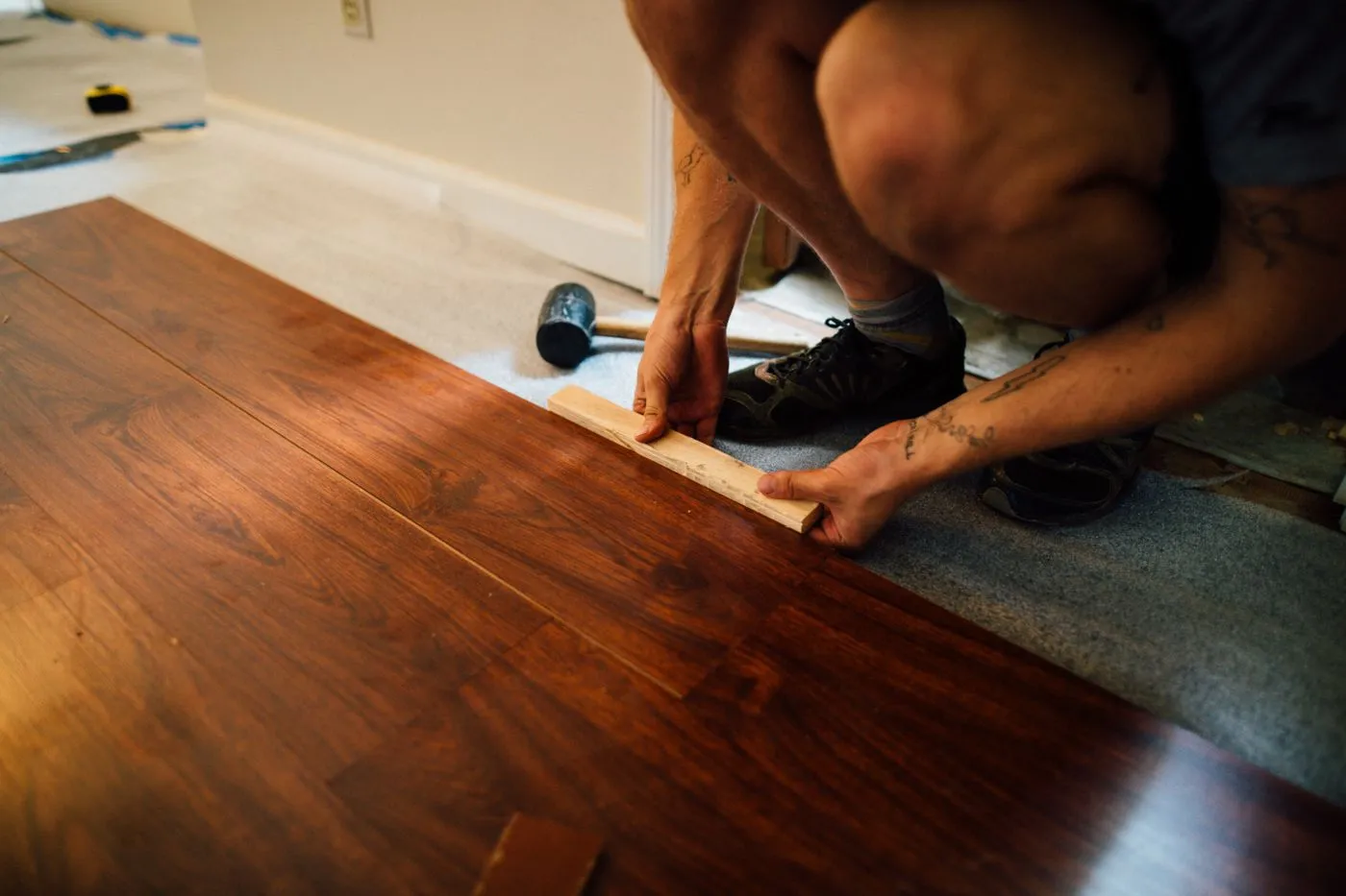 Installer laying wood plank flooring