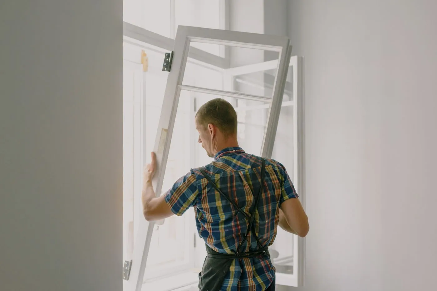 Installer fitting a new window frame