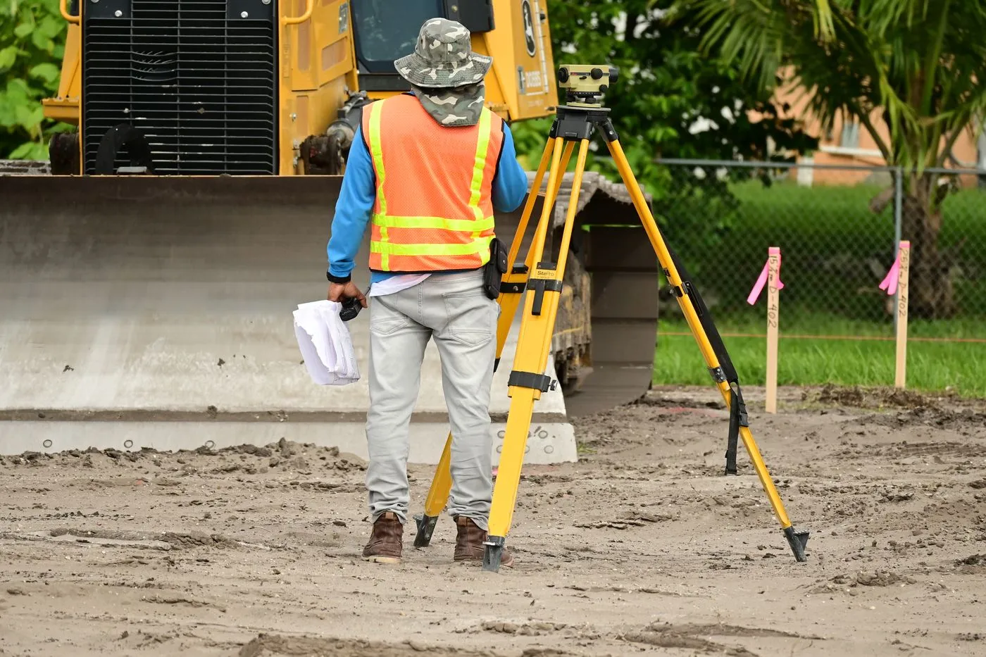 Surveyor with equipment on an active construction site