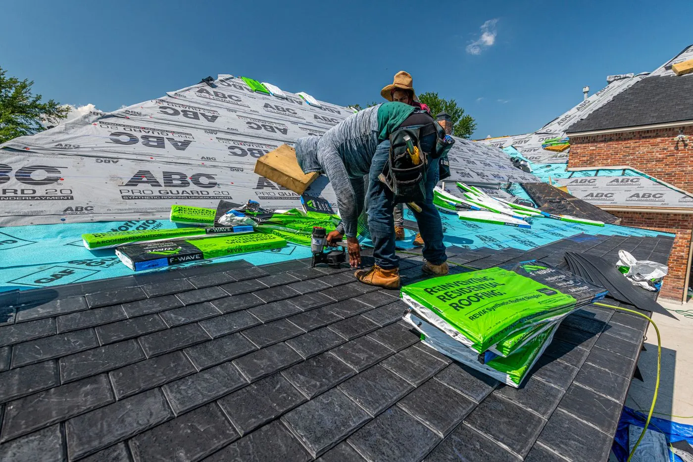 Roofers installing a new roof on a brick house in Fort Worth, Texas