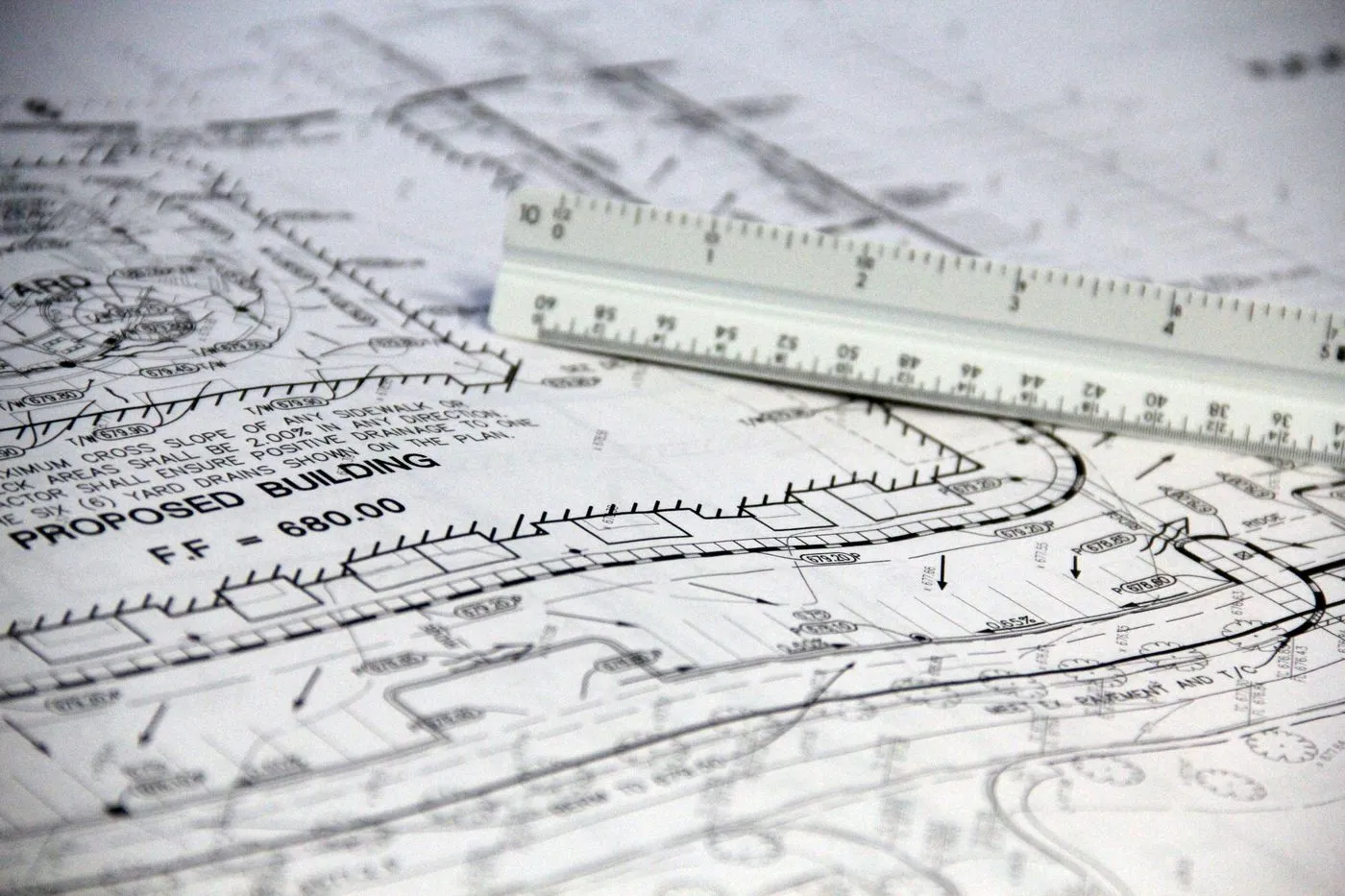 Architectural plan sheet with a scale ruler laid across it